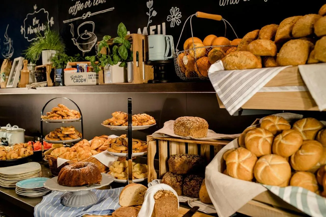 a bakery with lots of bread and pastries on display at Motel One Edinburgh-Royal in Edinburgh