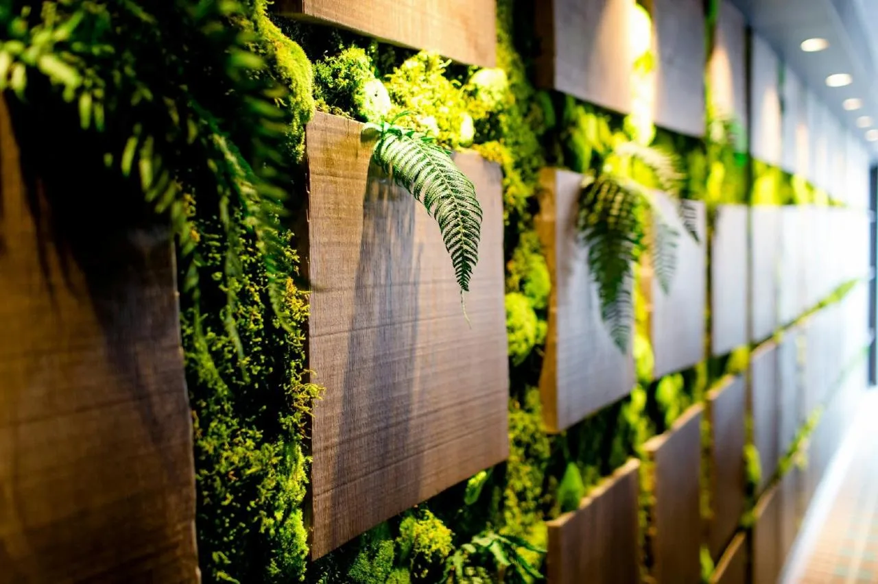 a green wall with plants on it at Motel One Edinburgh-Royal in Edinburgh