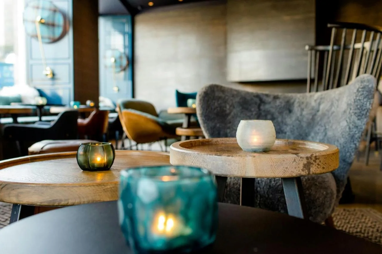 a restaurant with tables and chairs with candles on them at Motel One Edinburgh-Royal in Edinburgh